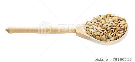 wood spoon with whole large green lentils isolated 79190519
