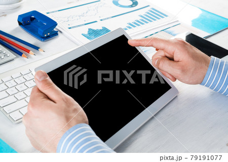 businessman with a tablet, works in the office businessman with a tablet, works in the office 79191077
