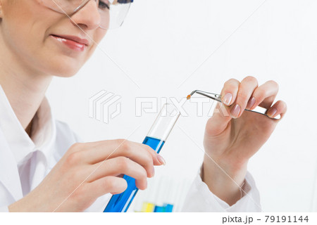 Scientist puts sample into test tube with liquid 79191144