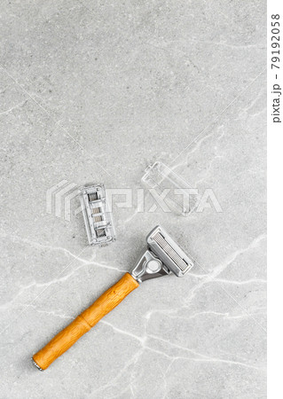 Shaving Razor with wooden handle on a grey marble Shaving Razor with wooden handle on a grey marble 79192058