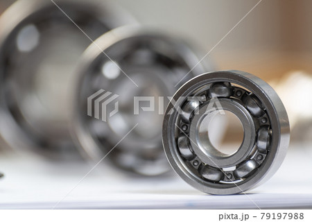 Three various ball bearings lying on paper sheet Three various ball bearings lying on paper sheet 79197988