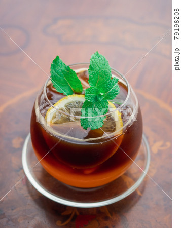 Iced lemon tea in a ball-shaped glass. Iced lemon tea in a ball-shaped glass. 79198203