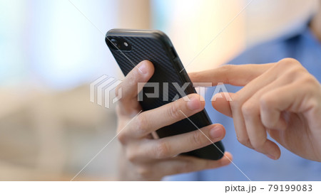 Close up of Hands of African Woman using Smartphone 79199083