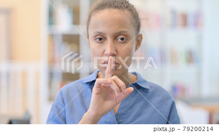 Portrait of African Woman Putting Finger on Lips, Quiet Sign 79200214