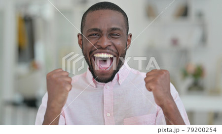 Portrait of Excited African Man Celebrating Success  79200254
