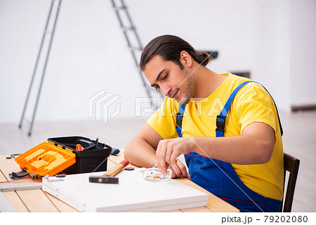 Young male carpenter working indoors 79202080