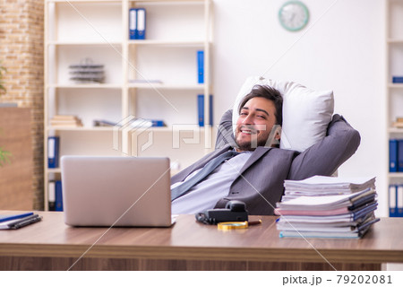 Young male employee in oversleeping concept 79202081