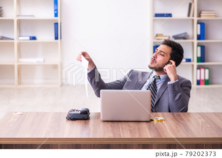 Young handsome businessman employee working in the office Young handsome businessman employee working in the office 79202373