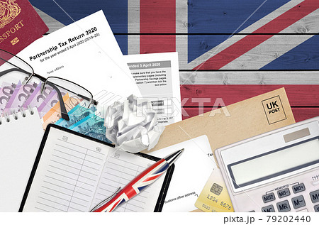 English Tax form sa800 Partnership tax return 2020 from HM revenue and customs lies on table with office items. HMRC paperwork and tax paying process in United Kingdom 79202440