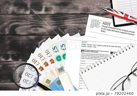 English form AD03 Change of location of the company records to the single alternative inspection location SAIL from Companies House service lies on table with office items 79202460