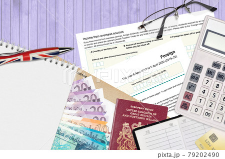 English Tax form sa106 Foreign from HM revenue and customs lies on table with office items. HMRC paperwork and tax paying process in United Kingdom 79202490