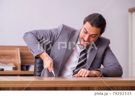 Young businessman employee sitting in the office Young businessman employee sitting in the office 79202535
