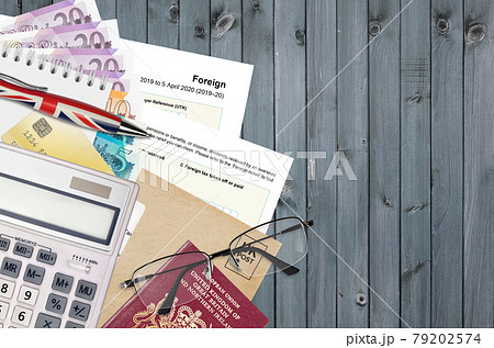 English Tax form sa106 Foreign from HM revenue and customs lies on table with office items. HMRC paperwork and tax paying process in United Kingdom 79202574