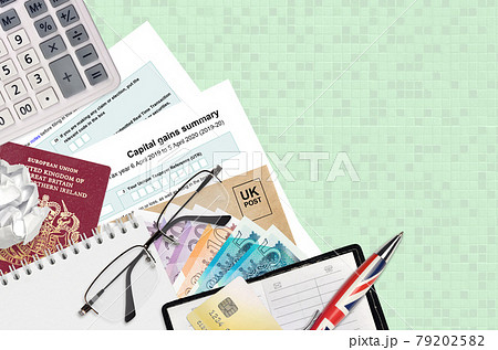 English Tax form sa107 Capital gains summary from HM revenue and customs lies on table with office items. HMRC paperwork and tax paying process in United Kingdom 79202582