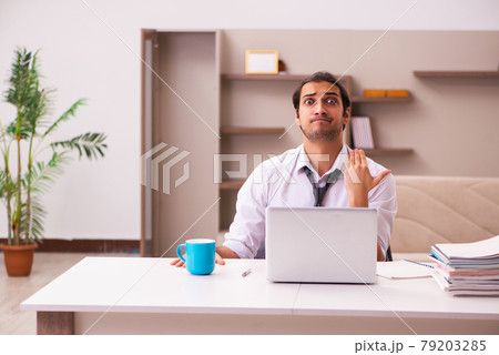 Young male employee working from home during pandemic Young male employee working from home during pandemic 79203285
