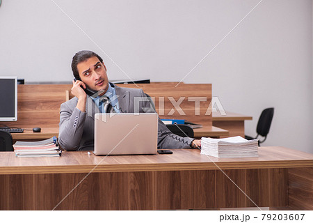 Young male employee working in the office 79203607