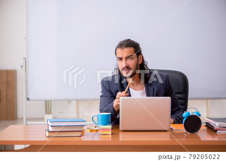 Young male teacher in the classroom Young male teacher in the classroom 79205022