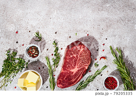 Food background with Fresh marbled beef rib eye steak, butter and spices. Trendy shadows Food background with Fresh marbled beef rib eye steak, butter and spices. Trendy shadows 79205335