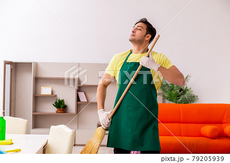 Young male contractor cleaning the house indoors 79205939