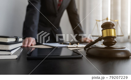 Professional lawyer considering with contract papers in courtroom. Justice, Law, Attorney and Court judge concept. Professional lawyer considering with contract papers in courtroom. Justice, Law, Attorney and Court judge concept. 79207229