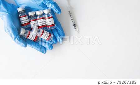 Covid-19 coronavirus vaccine bottle on doctor hand. Fight against Covid-19 coronavirus Concept. Covid-19 coronavirus vaccine bottle on doctor hand. Fight against Covid-19 coronavirus Concept. 79207385
