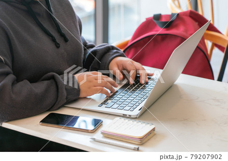 Woman hand in hoodie working on laptop Woman hand in hoodie working on laptop 79207902