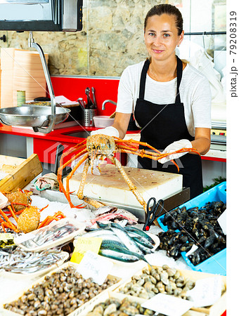 Adult woman demonstrating european spider crab Adult woman demonstrating european spider crab 79208319