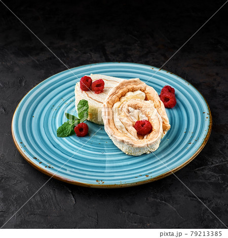Meringue roll cake with cream and raspberries. Roulade, summer dessert, closeup. Meringue roll cake with cream and raspberries. Roulade, summer dessert, closeup. 79213385