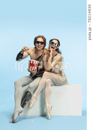 Movie lover. Young couple of ballet dancers in ancient Rome costums at blue studio. Movie lover. Young couple of ballet dancers in ancient Rome costums at blue studio. 79214930