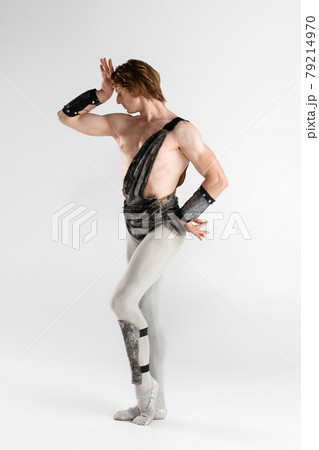 Spectacular man. Young male ballet dancer in ancient Rome costum posing at blue studio as historical image of Spartacus. Spectacular man. Young male ballet dancer in ancient Rome costum posing at blue studio as historical image of Spartacus. 79214970