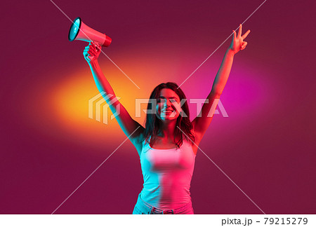 Caucasian young woman isolated on orange studio background in neon. Concept of human emotions, facial expression. Caucasian young woman isolated on orange studio background in neon. Concept of human emotions, facial expression. 79215279
