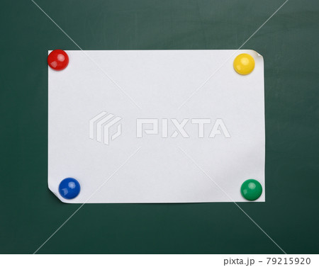 blank white sheet of a4 paper hanging on a green magnetic board. blank white sheet of a4 paper hanging on a green magnetic board. 79215920