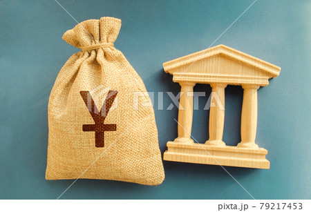 Yen, yuan money bag and government building. Business and finance concept. Deposit, loan and investment in to the bank. Credit. Help from the state. Subsidies and Benefits. Budget. 79217453