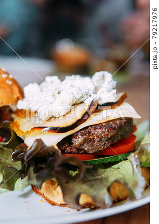 Burgers with beef and vegetables. Delicious burgers in a cooking class. Burger with onion sauce. 79217976
