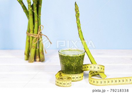 Ingridients for Smoothie of Fresh Green Vegetables and Fruits on Table. Equilibrium floating food. Healthy Alkaline diet. Balance. Copy Space. Vegetarianism. Measuring tape 79218338