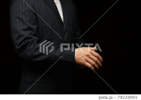 Caucasian man wearing a tuxedo fixing his cufflink. Caucasian man wearing a tuxedo fixing his cufflink. 79220065