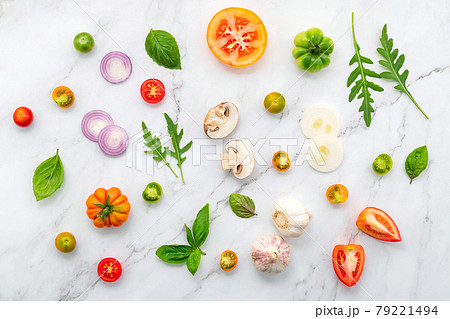 The ingredients for homemade pizza set up on white marble background. 79221494