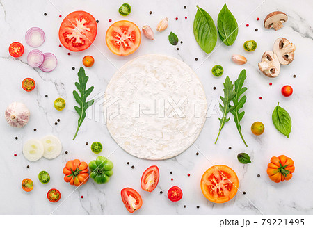 The ingredients for homemade pizza set up on white marble background. 79221495