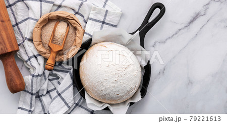 Fresh raw homemade yeast dough resting in cast iron skillet on marble table flat lay. 79221613