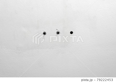 Hole and dowels in an old dirty white wall. Dowel pin inside old peeled wall for different editing projects Hole and dowels in an old dirty white wall. Dowel pin inside old peeled wall for different editing projects 79222453