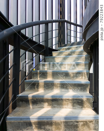 The concrete spiral staircase with the metal railing. The concrete spiral staircase with the metal railing. 79223843