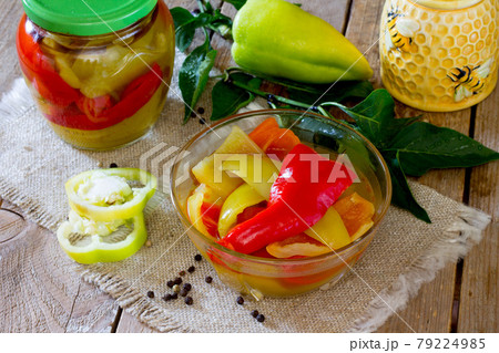 Home preservation. Vegetable salad in a jar on a wooden table.  79224985