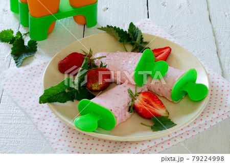 Eskimo strawberry, fruit ice on a wooden table. Eskimo strawberry, fruit ice on a wooden table. 79224998