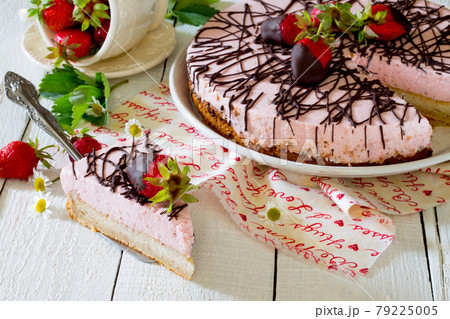 Cake with strawberries on a wooden table. Cake with strawberries on a wooden table. 79225005
