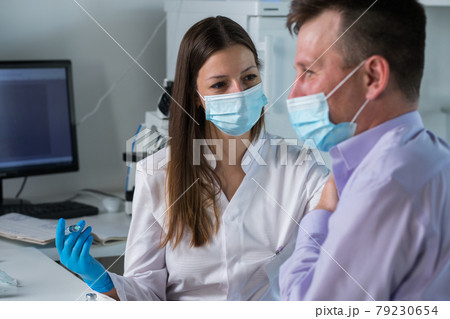 Female hands doctor nurse in latex gloves hold syringe with medicine vaccine, Female hands doctor nurse in latex gloves hold syringe with medicine vaccine, 79230654