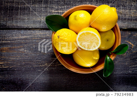 Fresh lemons in a bowl on the table, space for text. Fresh lemons in a bowl on the table, space for text. 79234983