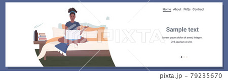woman freelancer sitting on bed using laptop stay home coronavirus pandemic quarantine concept 79235670
