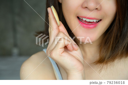 Cropped shot of young attractive Asian woman applying foundation powder puff on her face to cover flaws and change the natural skintone. Conceptual of women's beauty and cosmetic. 79236018