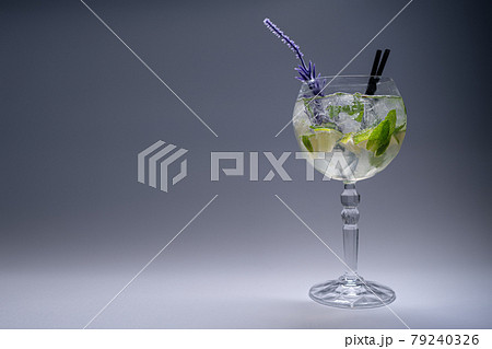cocktail hugo or mojito with mint, lime and ice in wineglass on white background 79240326