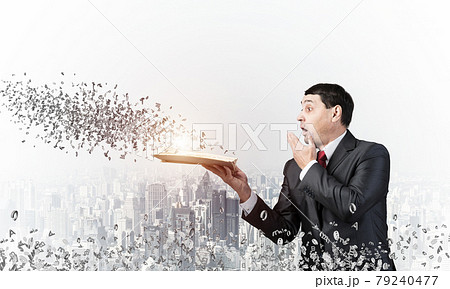 Embarrassed businessman covering mouth with hand 79240477